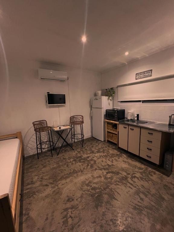 a kitchen with a refrigerator and a table and chairs at Quinta los Lopez in Azul