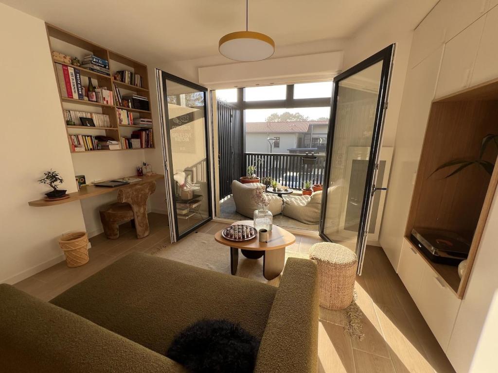 a living room with a couch and a table at Cozy apartment in Moliets-et-Maa