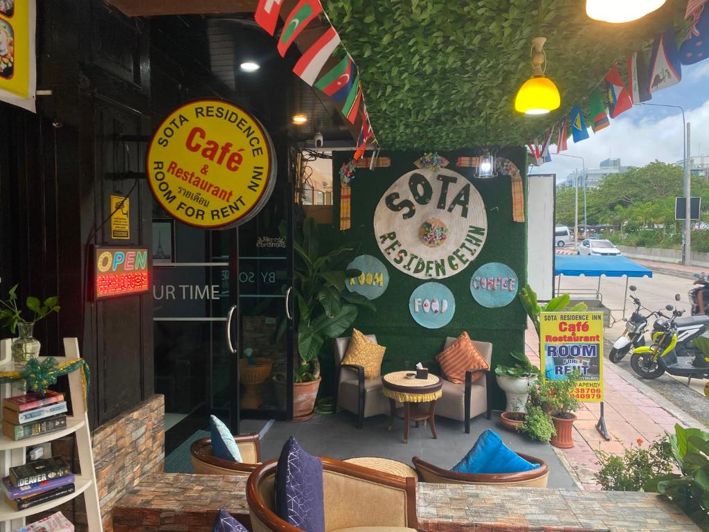 a restaurant with signs on the side of a building at Sota Residence in Pattaya South