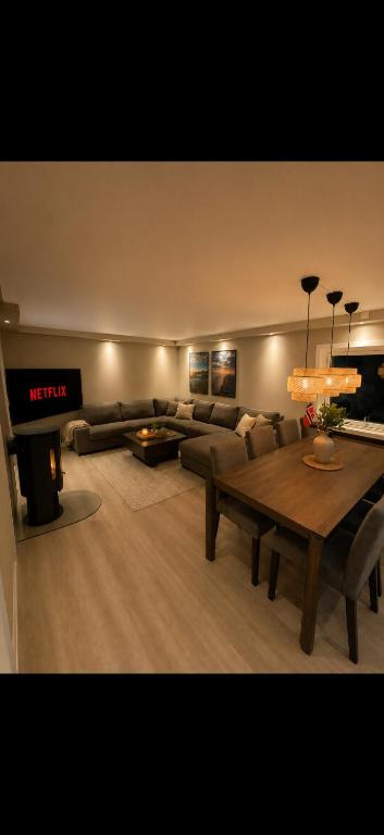 a living room with a couch and a table at Modern Ocean Escape, Lofoten in Sund