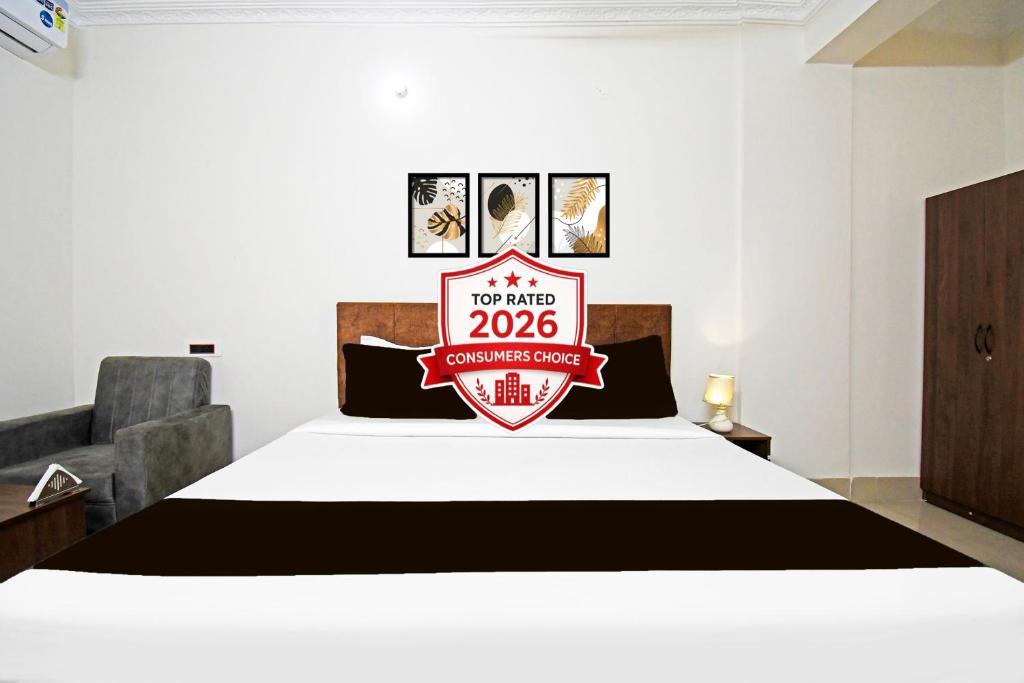 a bedroom with a bed with a sign on it at Super Collection O Raja Bazar Bailey Road in Patna