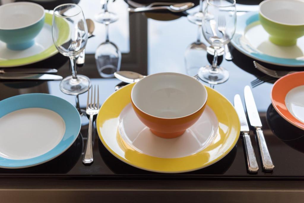 a table with plates and cups and forks and glasses at North Parade Avenue in Oxford