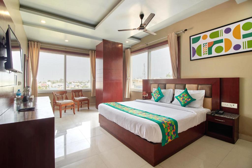 a hotel room with a bed and a dining room at Treebo Prem Tower in Haldwāni