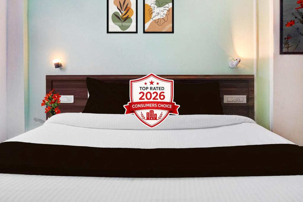 a bed with a sign that reads at Townhouse Ambegaon Road Katraj Formerly White Castle in Pune