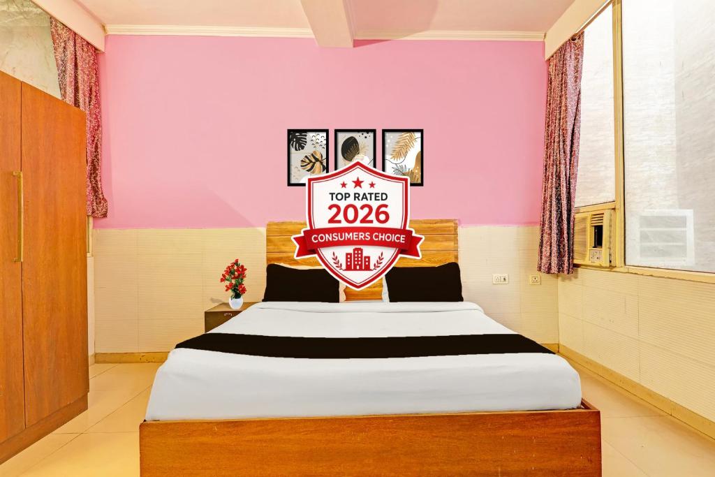 a room with a bed with a sign on it at Super Hotel O Kanode Gate Formerly Hotel Dhruv in Rewāri