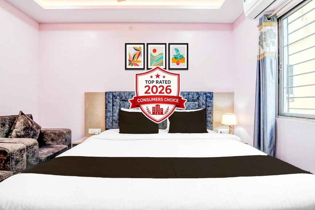a hotel room with a bed with a sign on it at Collection O SF Road Siliguri Formerly Jyoti Hotel in Siliguri