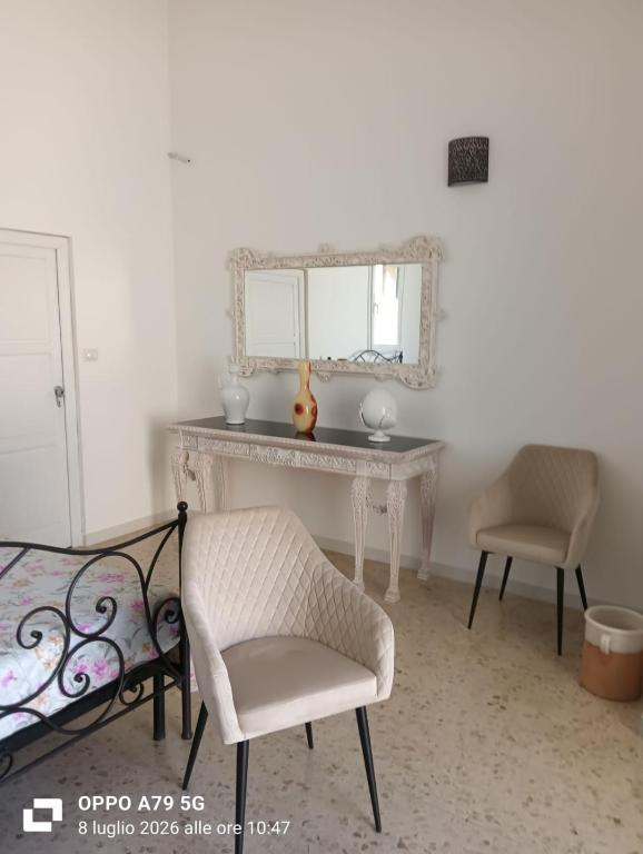 a bedroom with a dressing table and a mirror at Borghetto sant'irene in Erchie