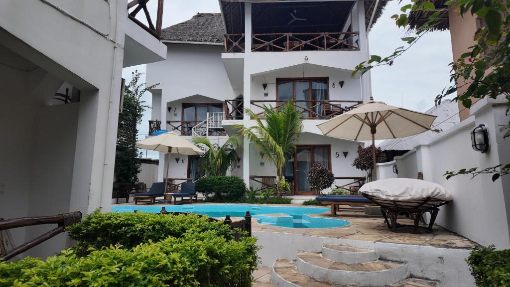 a view of the courtyard of a house with a swimming pool at Ocean view boutique in Nungwi
