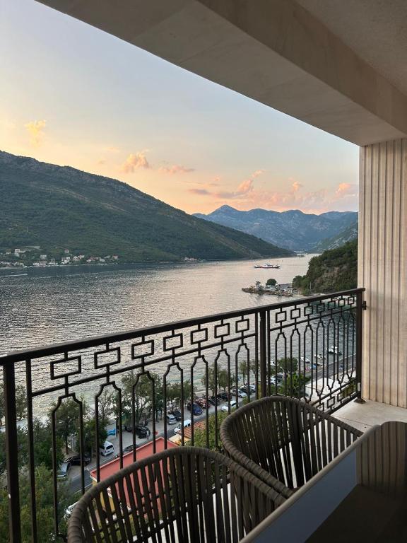 a balcony with chairs and a view of a river at L 32 Sea view in Lepetani
