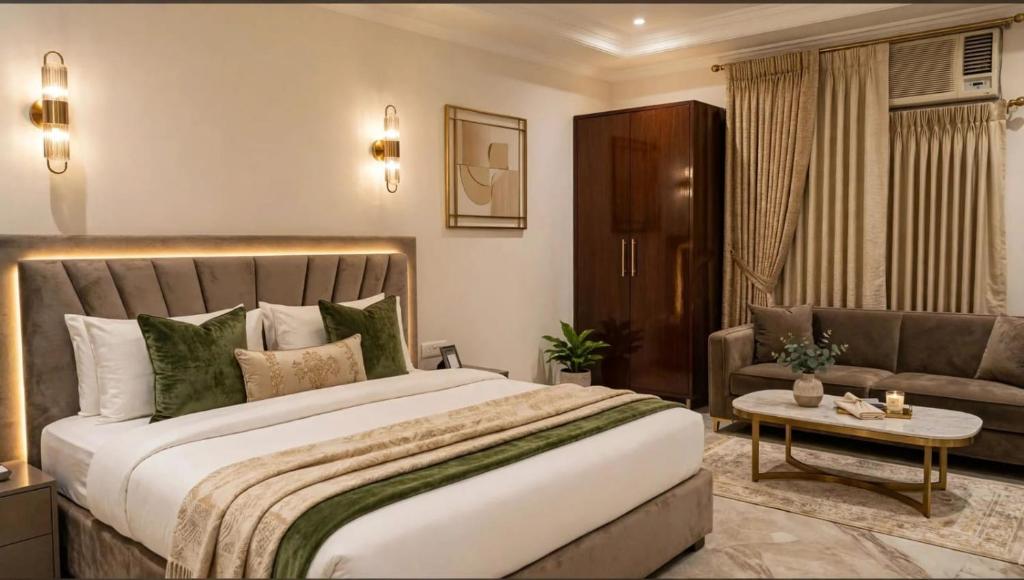 a bedroom with a large bed and a couch at Hotel teara in Gwalior