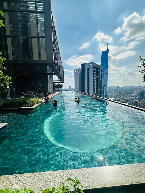 a swimming pool on the top of a building at Lucentia Residence BBCC Modern City View Stay in Kuala Lumpur