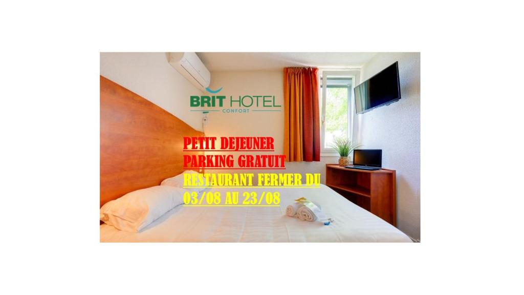 a bedroom with a bed with a sign on it at Brit Hotel Reims La Pompelle in Reims