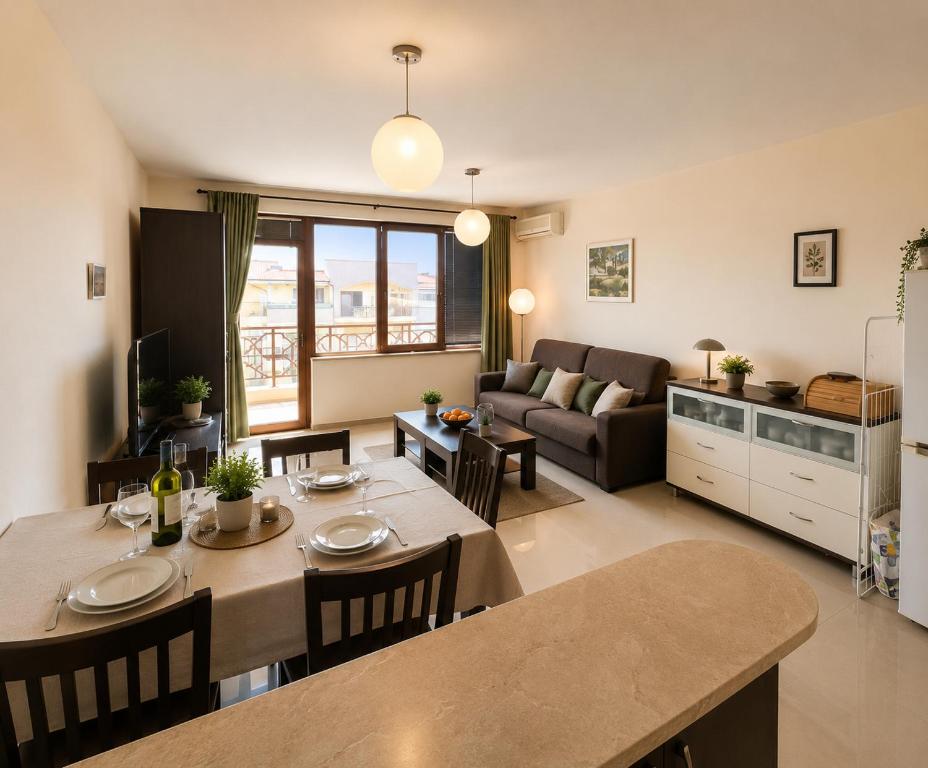 a kitchen and living room with a table and chairs at Spacious 2 bedroom apartment in Balchik