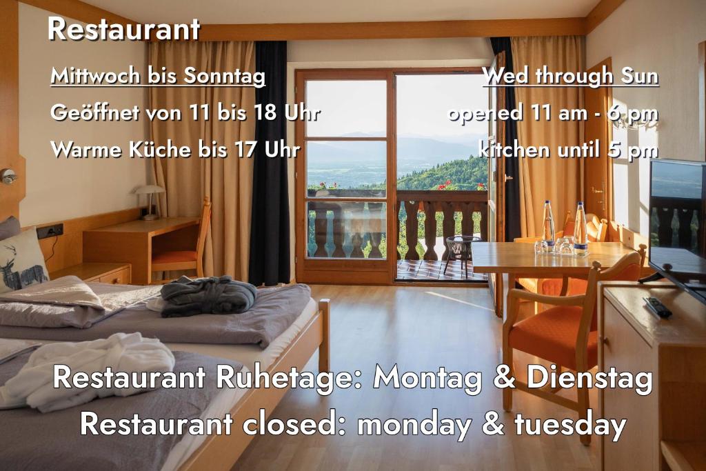 a room with a bed and a desk and a balcony at Neubichler Alm in Piding