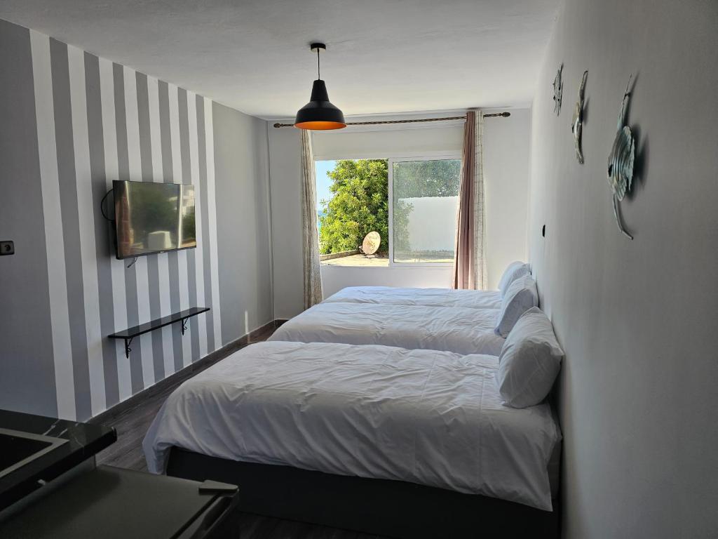 a bedroom with two beds and a window at Chambre d'hôte plage Dalia in Dalia