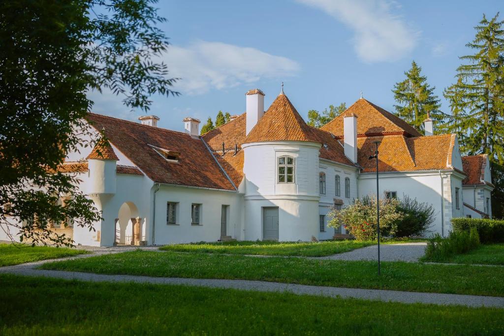 a large white house with red roof at Polixenia Culinary Estate 