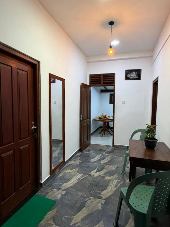 a hallway with a door and a table and chairs at Sunny's Hide Out in Talalla South
