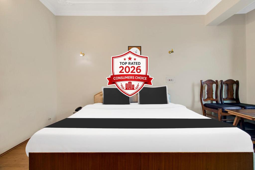 a bed with a sign that reads no more at Super Townhouse Rajbagh Formerly Hotel Modern in Srinagar