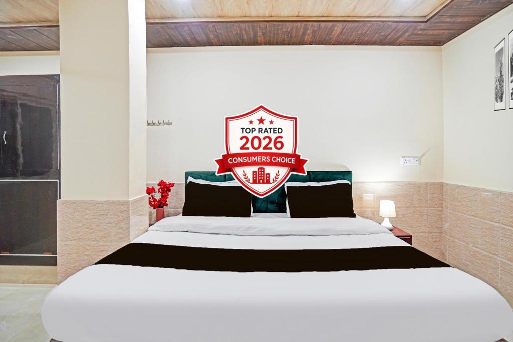 a large bed with a sign that reads top mine at Super OYO Hotel O Varanasi Banaras Junction Formerly Girija Palace in Varanasi