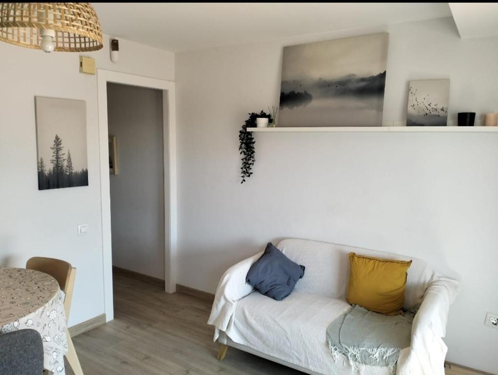 a living room with a white couch with pillows on it at Where Mediterranean colours meets you in Terrassa