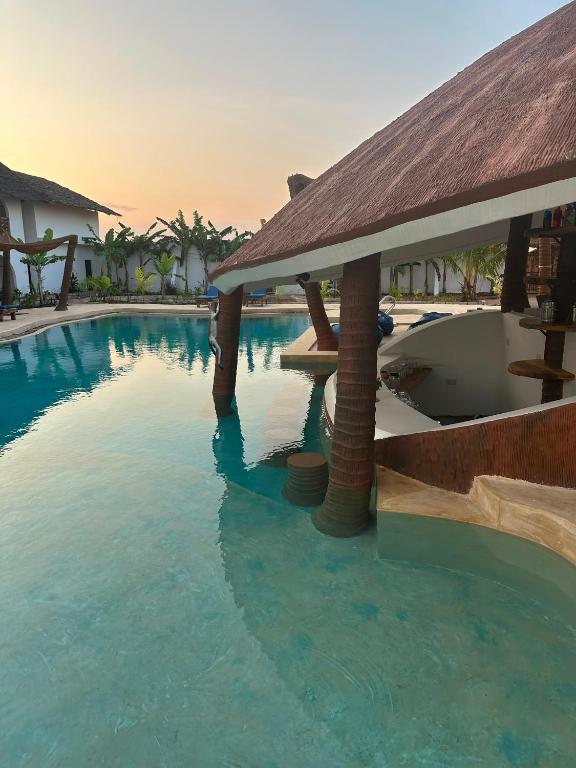 a swimming pool in a resort with a resort at Faro Resort in Nungwi