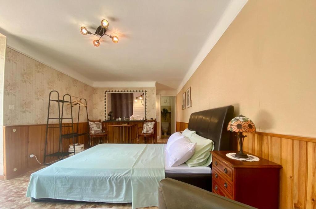 a bedroom with a bed and a couch at Chez Chagall cozy studio in Sarlat-la-Canéda