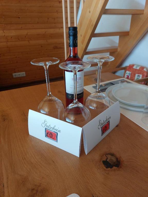 two wine glasses sitting on top of a table at Maisonette auf 1000m mit Sauna in Schönwald
