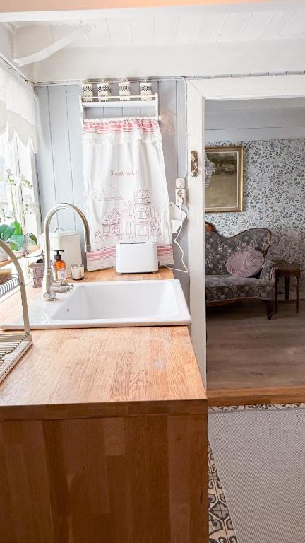 a kitchen with a sink and a window at Charming and historic house in Flekkefjord
