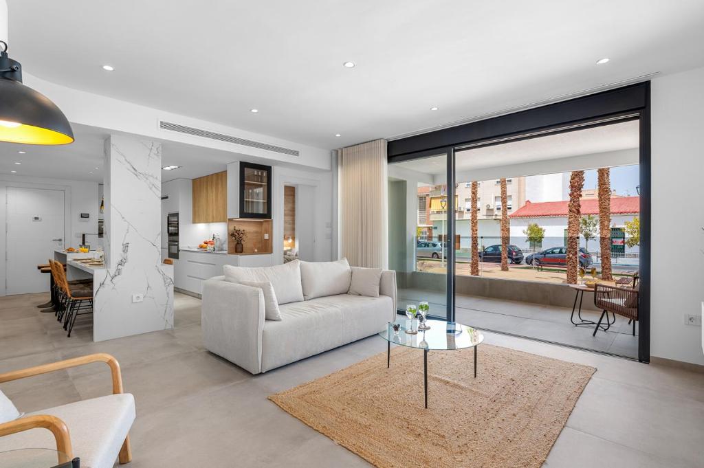 a living room with a couch and a table at Pinatar Luxury in San Pedro del Pinatar