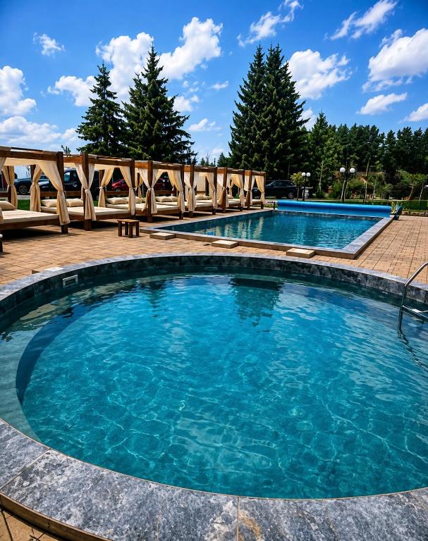 a pool with blue water in a resort at Alpina Lux in Kopaonik