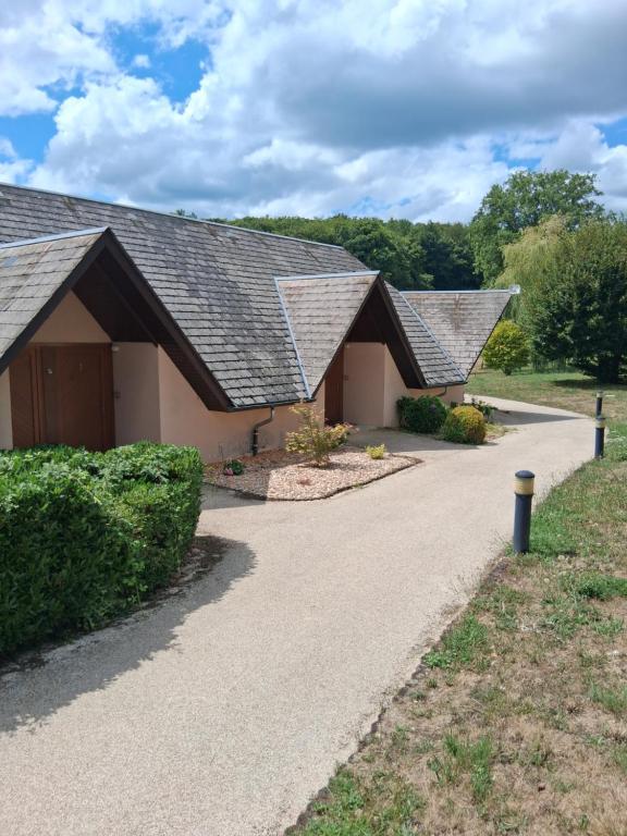a group of three buildings with a driveway at La maiade in Chirac-Bellevue