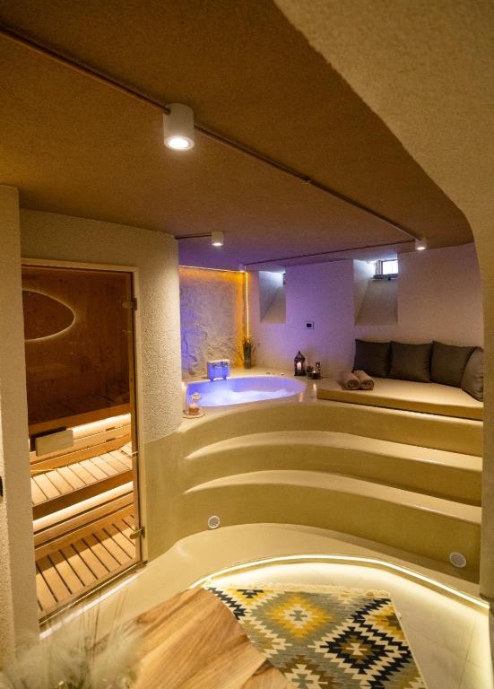 a room with a bath tub in the middle of a room at Orama Suite & Spa in Korçë