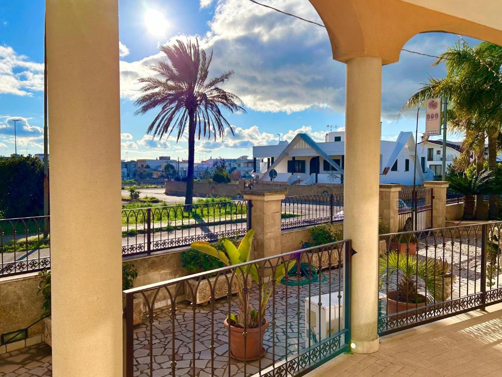 a view of a palm tree from a balcony at Perla Residence - Salve in Salve