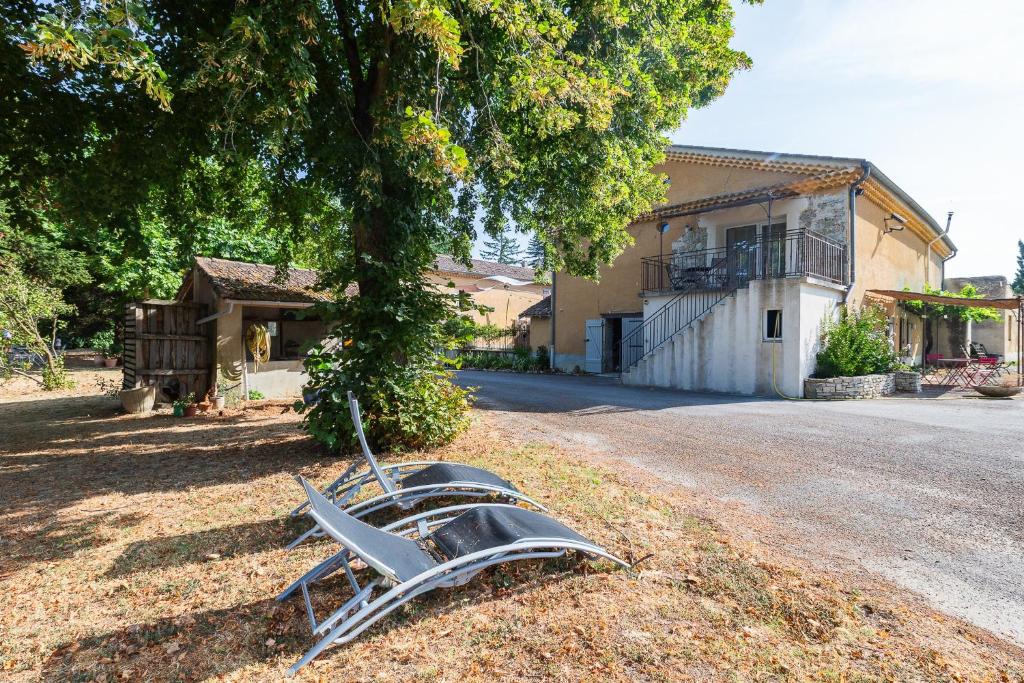 a metal object sitting on the ground under a tree at L'ormeau in Charols