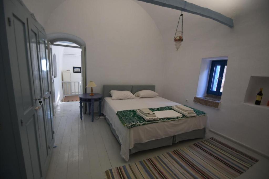 a bedroom with a bed and a table in a room at Avgonima Sunset Medvial Suite in Chios