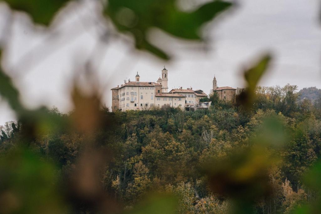 an old castle on top of a hill at BORGO MONCHIERO HERITAGE by Atmosphere in Monchiero