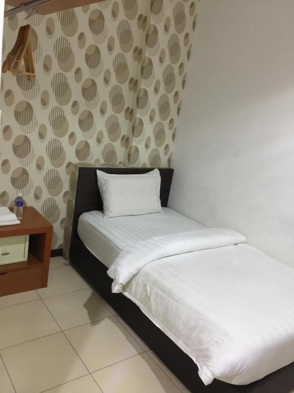 Postel nebo postele na pokoji v ubytování Permai Hotel