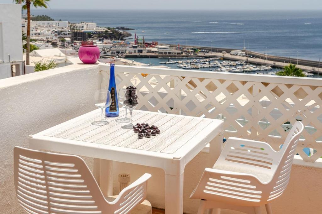 a white table and chairs with a view of the ocean at Vittorio Fabulous View in Tías