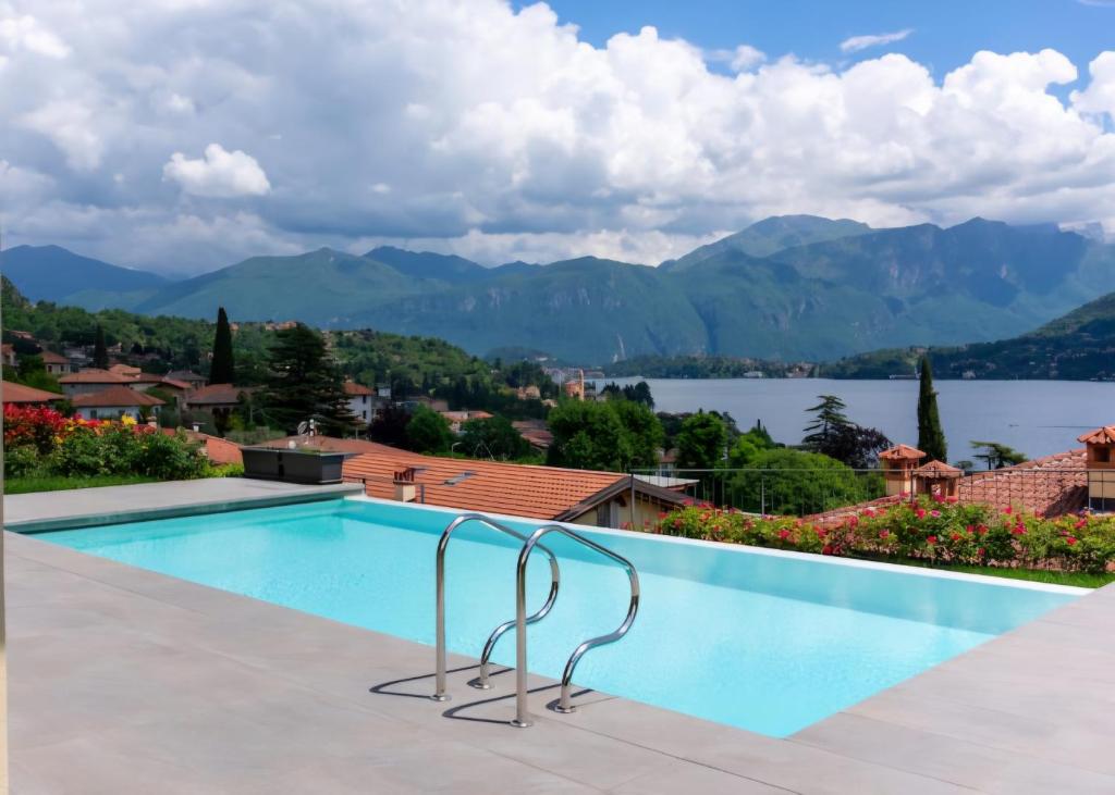 a swimming pool with a view of the lake and mountains at Villa Incanto in Mezzegra