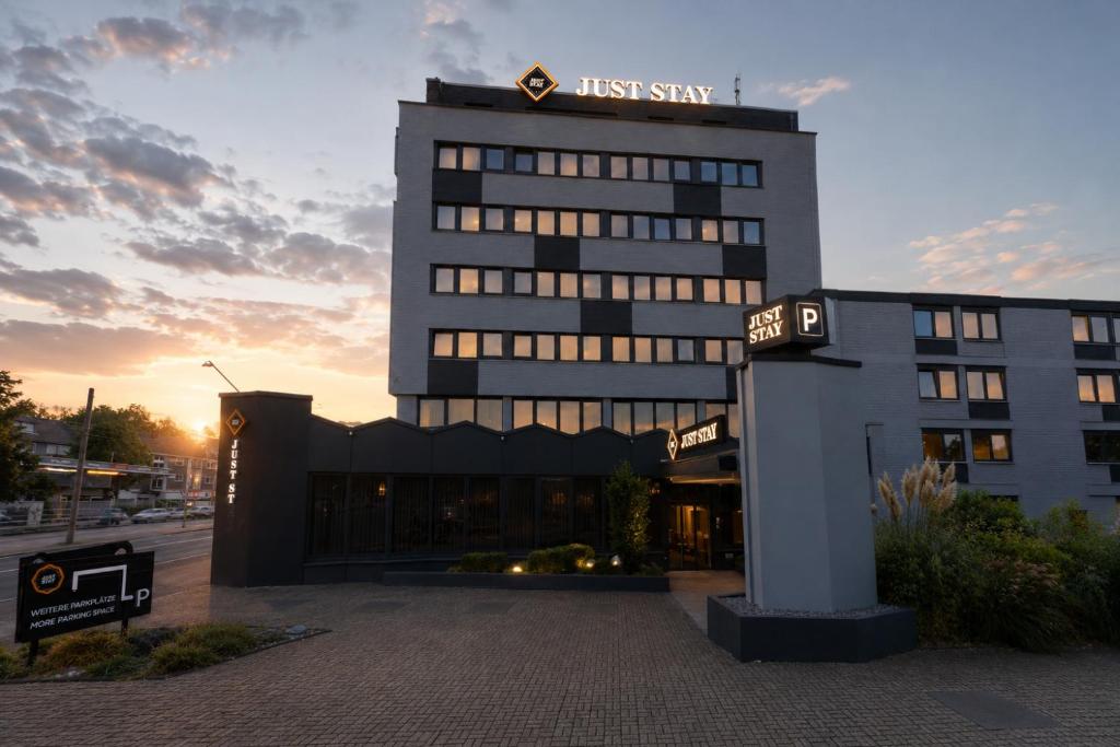 a building with a first stay sign in front of it at JustStay Mülheim Oberhausen Hotel & Apartments in Mülheim an der Ruhr