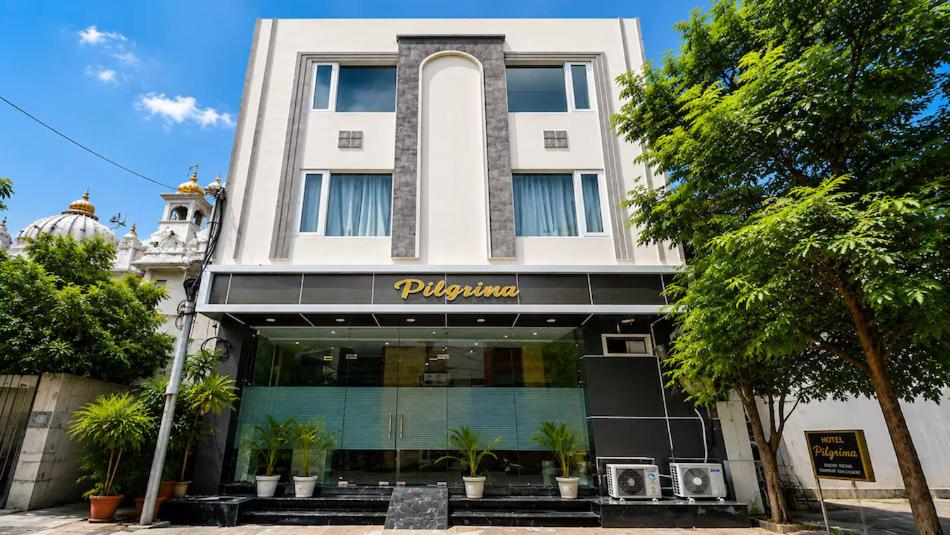 a building with a sign on the front of it at Hotel Pilgrim Near Golden Temple in Amritsar