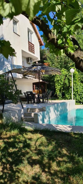 a house with a swimming pool next to a building at Villa M&E Oasis with Private Pool in Košelji