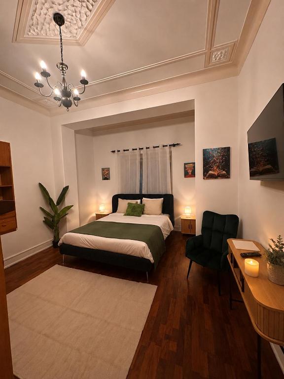 a bedroom with a bed and a chair in it at Casa do Jardim in Peniche