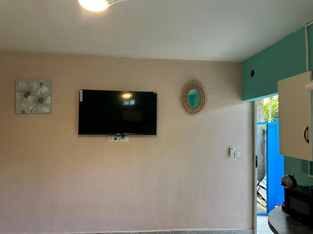 a flat screen tv on the wall of a living room at Ouzouri Wa Lijou in Mzouazia