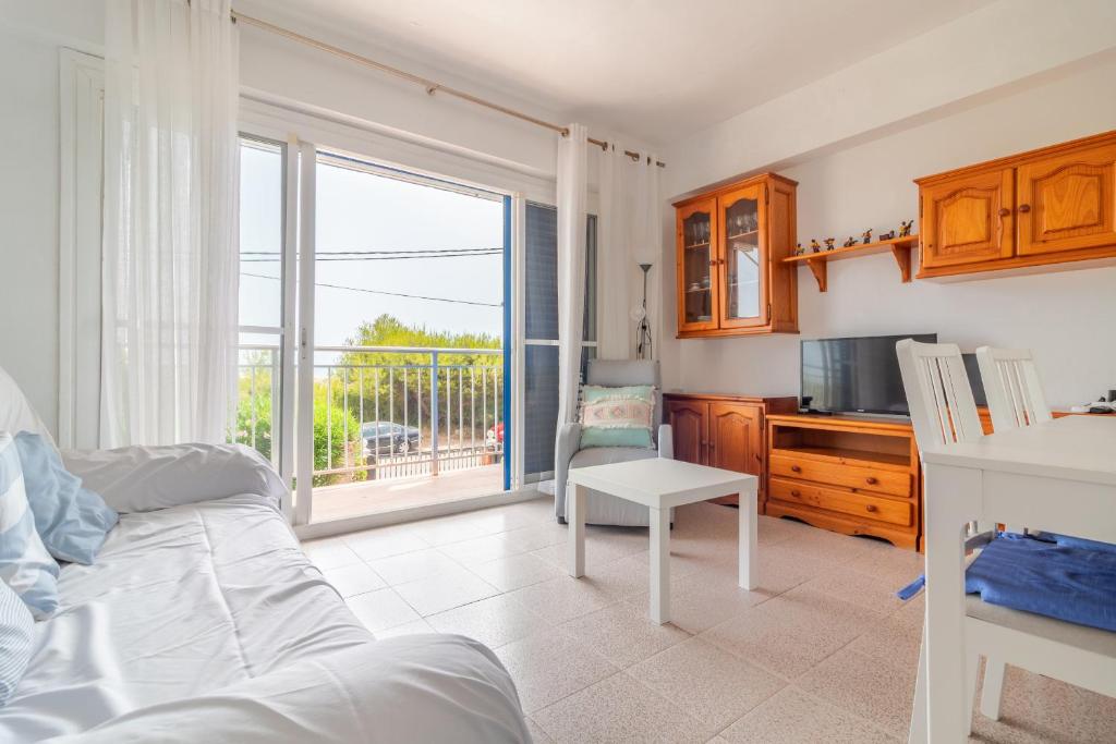 a bedroom with a bed and a kitchen with a balcony at Apt Italia 96 in Almarda