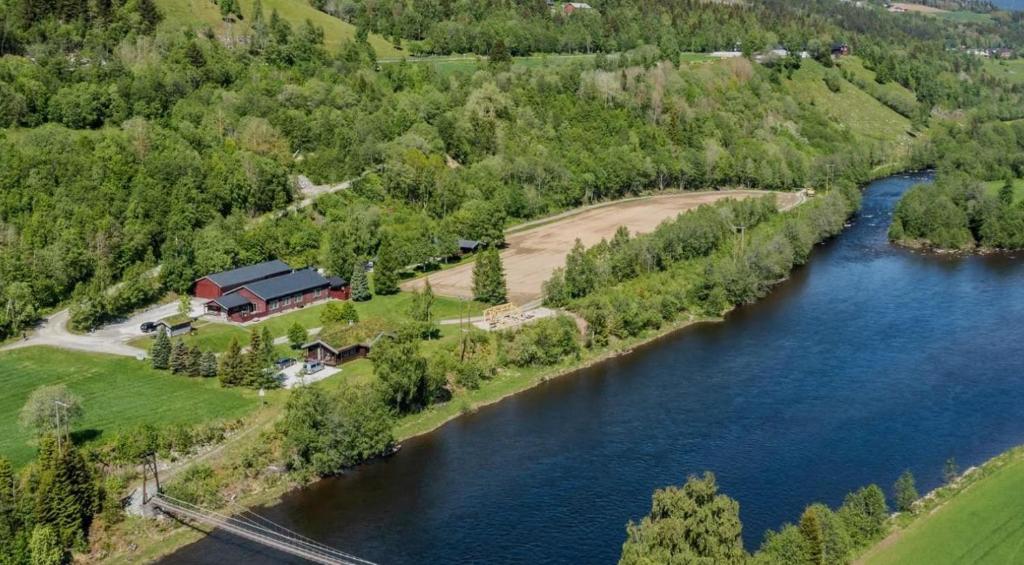 an aerial view of a house next to a river at Grindal Salmon Lodge in Rennebu