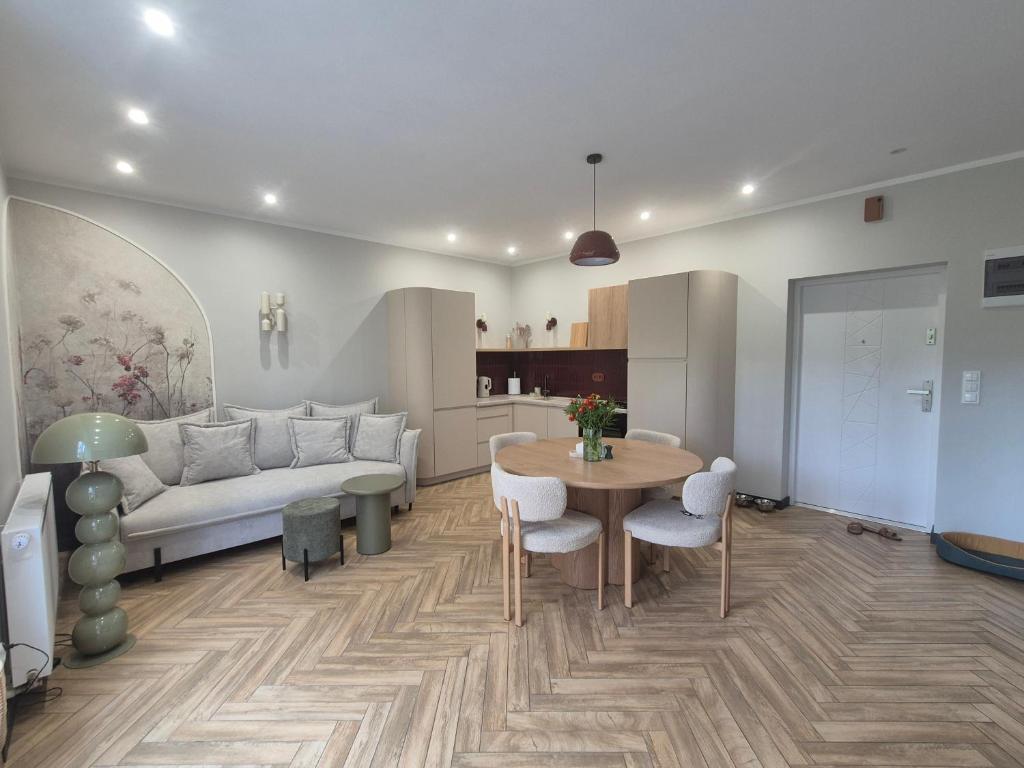 a living room with a couch and a table at Apartamenty u Justyny - Ametyst in Borne Sulinowo