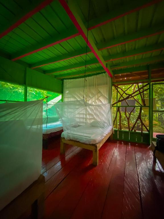 a room with a hammock in a tent at Reserva Natural Tucuchira in Santa Sofía