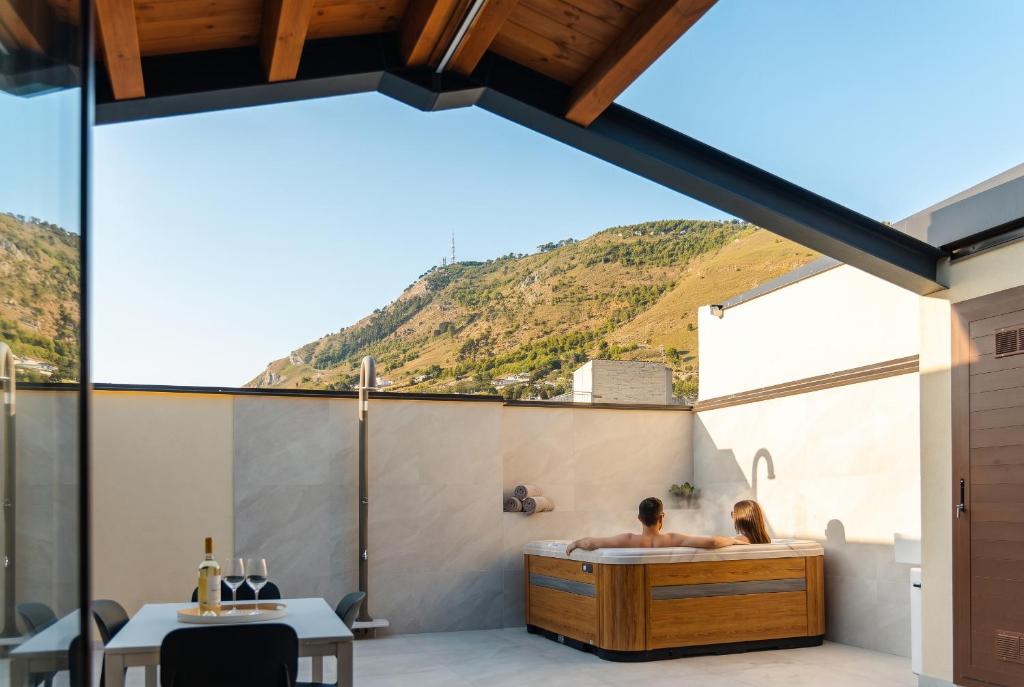 a man in a bath tub in a house at Antiche Cantine Bed & Breakfast in Alcamo