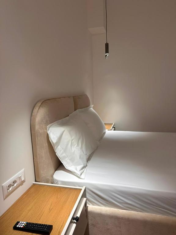a small bedroom with a bed with a pillow on it at Zac's Rooms in Dukat